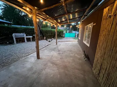 a covered patio with a bench on the side of a building at La casita the Aye in Villa Carlos Paz