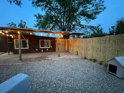 a backyard with a fence and a house at La casita the Aye in Villa Carlos Paz