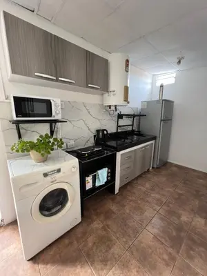 a kitchen with a washing machine and a refrigerator at La casita the Aye in Villa Carlos Paz