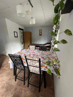 a dining room with a table and chairs and a table and chairs at La casita the Aye in Villa Carlos Paz