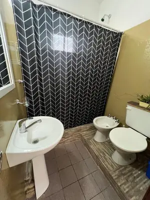 a bathroom with a sink and a toilet at La casita the Aye in Villa Carlos Paz