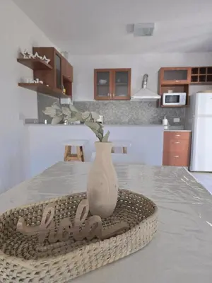 a white vase sitting on a table in a kitchen at Posta Espinillos 12 in Villa General Belgrano