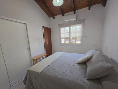 a bedroom with a large bed with a window at Posta Espinillos 12 in Villa General Belgrano