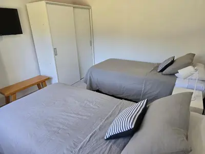 a room with two beds and a mirror at Posta Espinillos 12 in Villa General Belgrano