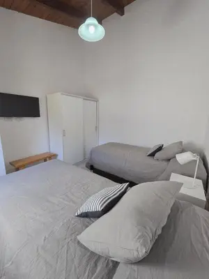 a bedroom with two beds and a lamp at Posta Espinillos 12 in Villa General Belgrano
