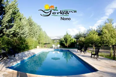 a swimming pool in a yard with chairs around it at Yerba Buena casas de campo - Nono in Nono