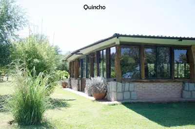 a pavilion in a garden with potted plants at Yerba Buena casas de campo - Nono in Nono