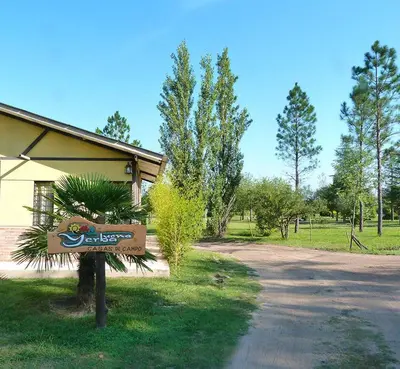 a sign in the grass in front of a building at Yerba Buena casas de campo - Nono in Nono