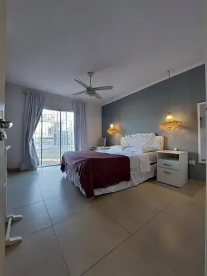a bedroom with a bed and a ceiling fan at Casa en Estancia Vieja a 5 min del centro de Carlos Paz in Villa Carlos Paz
