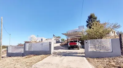 a truck is parked in front of a house at Casa en Estancia Vieja a 5 min del centro de Carlos Paz in Villa Carlos Paz