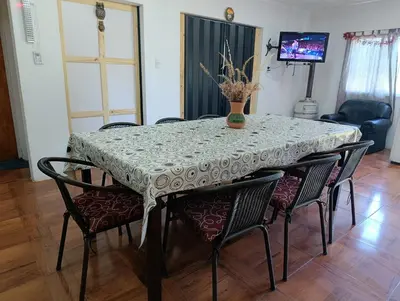 a dining room table with chairs and a table cloth at La Morada de sus Sueños Caeiro in Bialet Massé