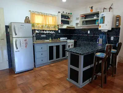a kitchen with a refrigerator and a counter top at La Morada de sus Sueños Caeiro in Bialet Massé
