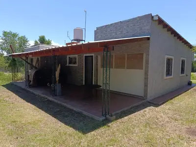 a house with a large deck with a garage at La Morada de sus Sueños Caeiro in Bialet Massé