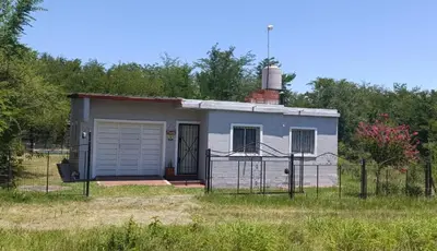 a small house with a garage in a field at La Morada de sus Sueños Caeiro in Bialet Massé