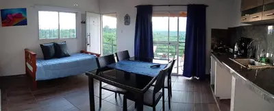 a living room with a couch and a table at Balcones del Rio in Santa Rosa de Calamuchita