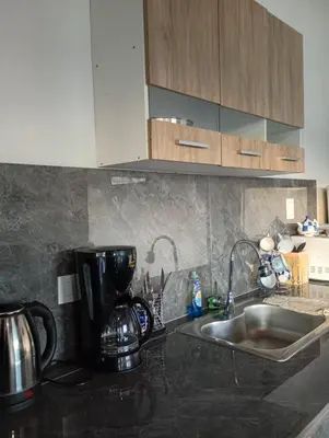 a kitchen counter with a coffee maker and a sink at Balcones del Rio in Santa Rosa de Calamuchita