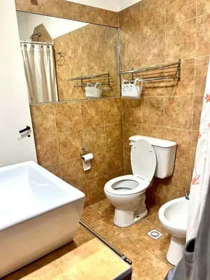 a bathroom with a toilet and a sink at Casa alquiler temporario, Cerro, Córdoba in Cordoba