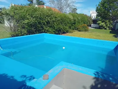 a pool with blue water in a yard at Casa alquiler temporario, Cerro, Córdoba in Cordoba