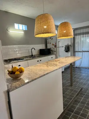 a kitchen with two pendant lights and a bowl of fruit on a counter at Casa alquiler temporario, Cerro, Córdoba in Cordoba