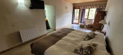 a bedroom with a large bed with two pillows on it at Aldea de los Cerros in Villa Yacanto