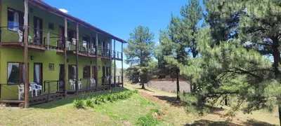 a building with balconies on the side of it at Aldea de los Cerros in Villa Yacanto