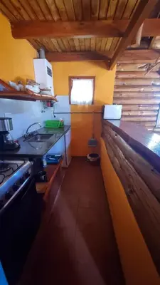 a small kitchen with a sink and a stove at Aldea de los Cerros in Villa Yacanto