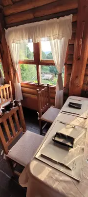 a dining room with a table and chairs and a window at Aldea de los Cerros in Villa Yacanto