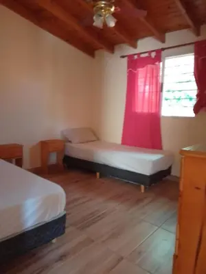 a bedroom with two beds and a window at Casa Miranda in Merlo