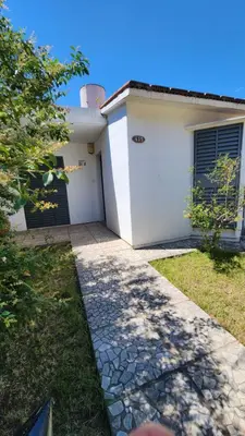 a white house with a door and a stone driveway at El Descanso Placentero 3 Habitaciones in Cordoba