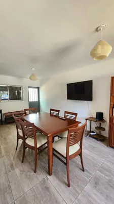 a dining room with a table and chairs and a tv at El Descanso Placentero 3 Habitaciones in Cordoba