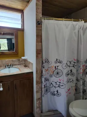 a bathroom with a shower curtain with bicycles on it at Bella Vista in Bialet Massé