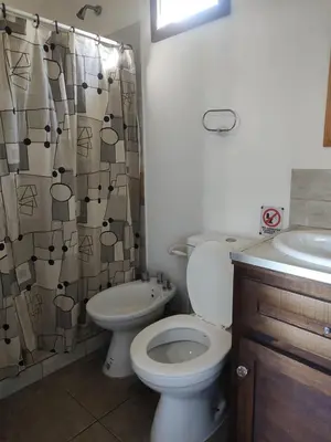 a bathroom with a toilet and a shower curtain at Bella Vista in Bialet Massé