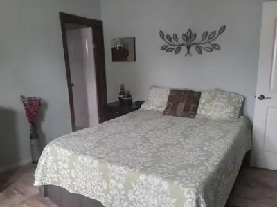 a bedroom with a bed with a comforter on it at Bella Vista in Bialet Massé