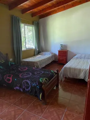 a bedroom with two beds and a window at Casita de los recuerdos in Villa Carlos Paz