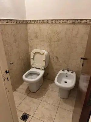 a bathroom with a toilet and a bidet at Gravensteen Urca in Cordoba