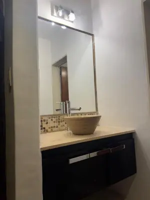 a bathroom with a sink with a large mirror at Gravensteen Urca in Cordoba