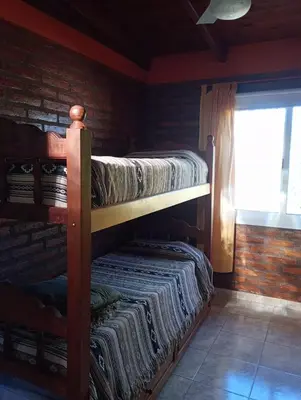 two bunk beds in a room with a window at Cabañas Yarel in Alpa Corral