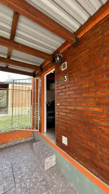 a brick wall with an entrance to a building at Cabañas Yarel in Alpa Corral