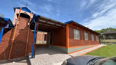 a small house with a large wheel in front of it at Cabañas Yarel in Alpa Corral