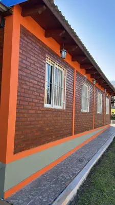 a red brick building with windows on it at Cabañas Yarel in Alpa Corral