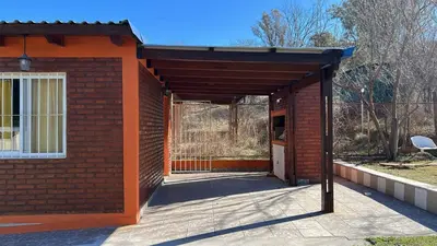 a red brick building with an open door at Cabañas Yarel in Alpa Corral
