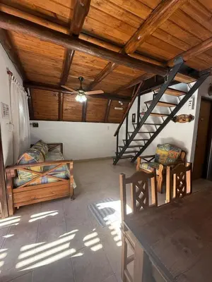 a bedroom with a bunk bed and a wooden ceiling at Cabañas Pindahue - Alojamiento Huilen in Villa Carlos Paz