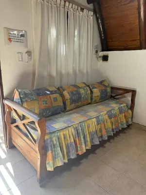 a large wooden bed in a room at Cabañas Pindahue - Alojamiento Huilen in Villa Carlos Paz