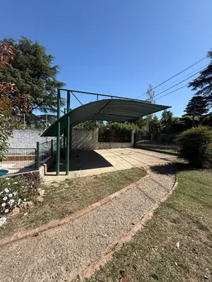 a bus stop with a canopy in a park at Cabañas Pindahue - Alojamiento Huilen in Villa Carlos Paz