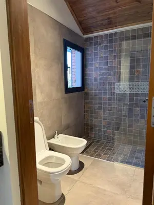 a bathroom with a toilet and a sink and a shower at Agua de Tajamar in Alta Gracia