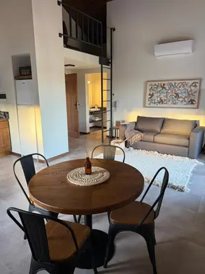 a wooden table and chairs in a living room at Agua de Tajamar in Alta Gracia