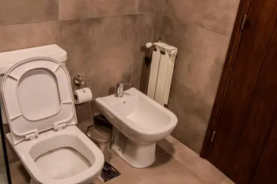 a bathroom with a toilet and a sink at Agua de Tajamar in Alta Gracia