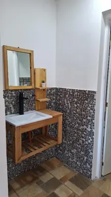 a bathroom with a sink and a mirror at Napoles complejo in Villa de Las Rosas