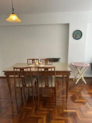 a dining room with a wooden table and chairs at Mandala Apart in Cordoba