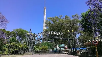 a sign in front of a park with a tower at Mandala Apart in Cordoba